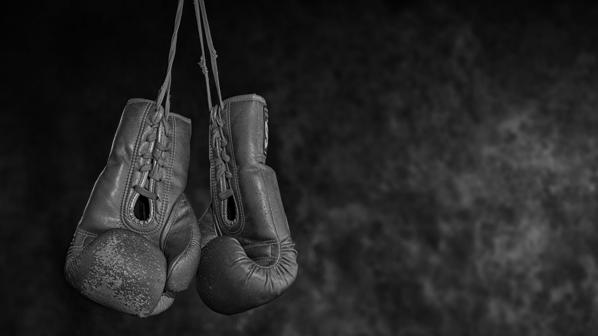 Man strapping boxing gloves